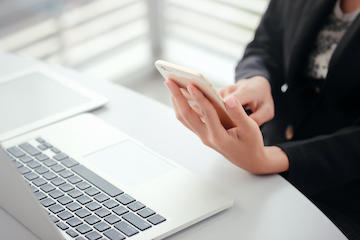 person with calculator and laptop