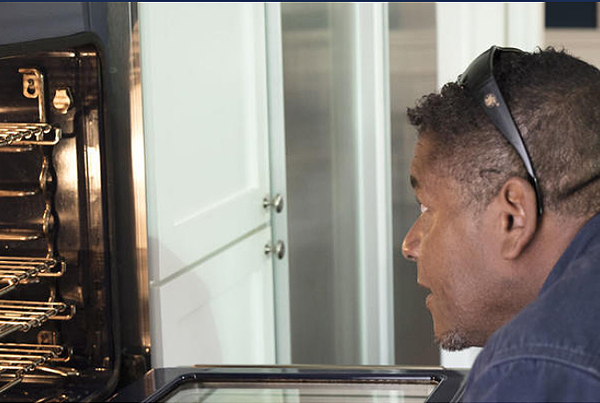 service technician checking furnace