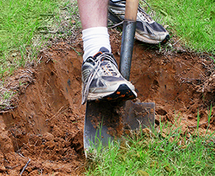 person digging with a shovel