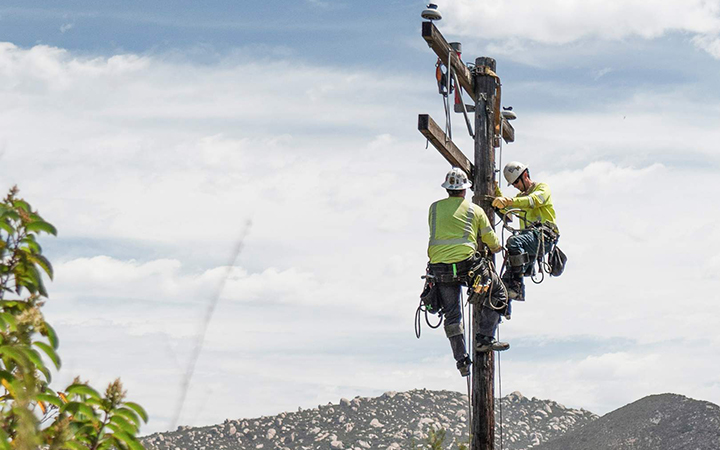 Lineworker on electric pole