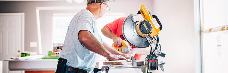 two men working with saw