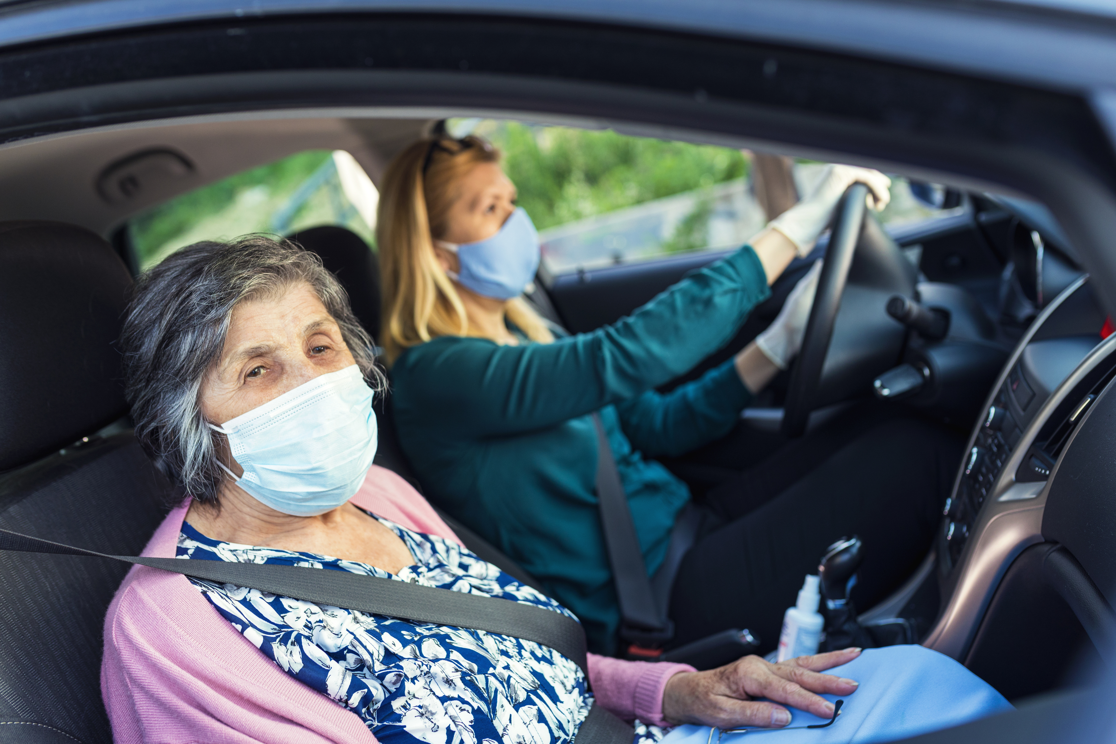 Women in car with covid masks image