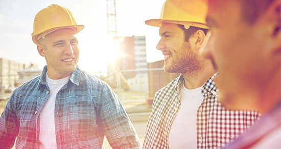 Men in construction hats having a converstation