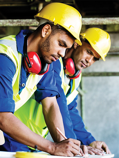 Two construction workers looking at plans for project